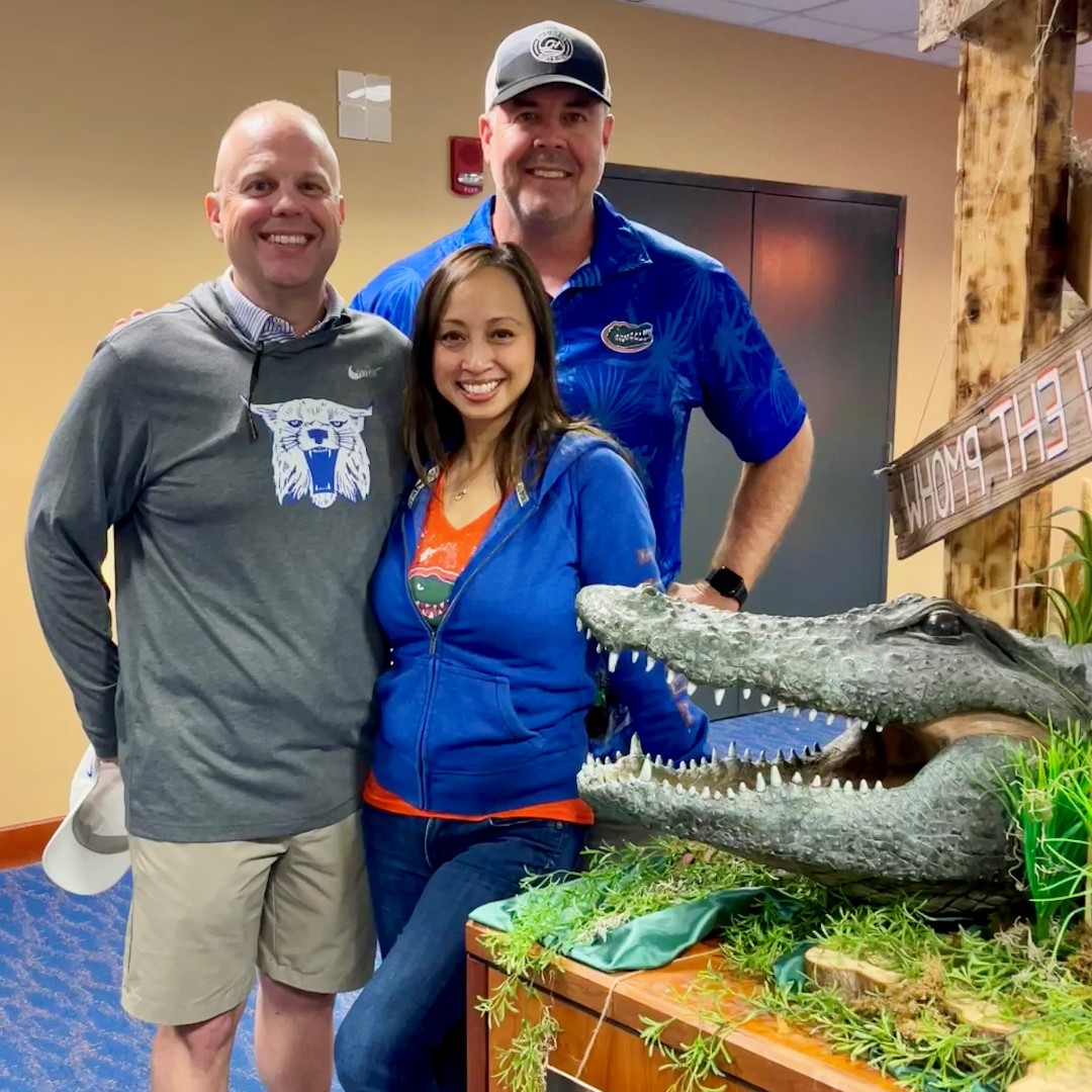 cmrpartners's tweet photo. Game day spirit shines bright, even on opposing sides! Jeni Dzenis and Ken Blumbek rock their Florida gear, while Chris Watson puts on a brave face in his Kentucky colors after the Gators' win. At CMR Partners, we unite for the ultimate win: teamwork! 💪🎉 https://t.co/7dDjM2aFx0