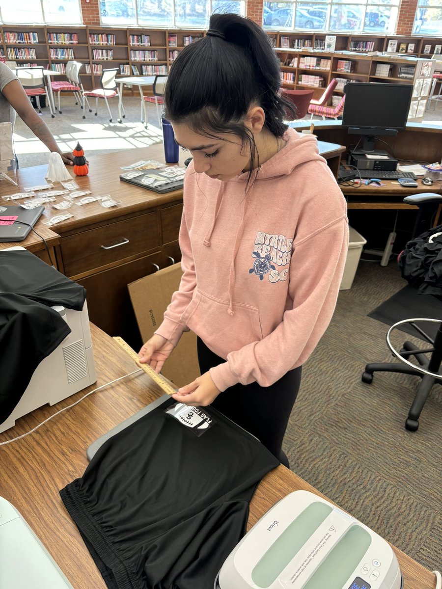 rchlmc's tweet image. @SGHSStorm Teacher Cadets are in the Media Center today doing service learning for teachers! This student is using our makerspace to heat press custom decals onto shorts for our new flag football team. #GCSLibrariesEngage @GCSchoolsNC