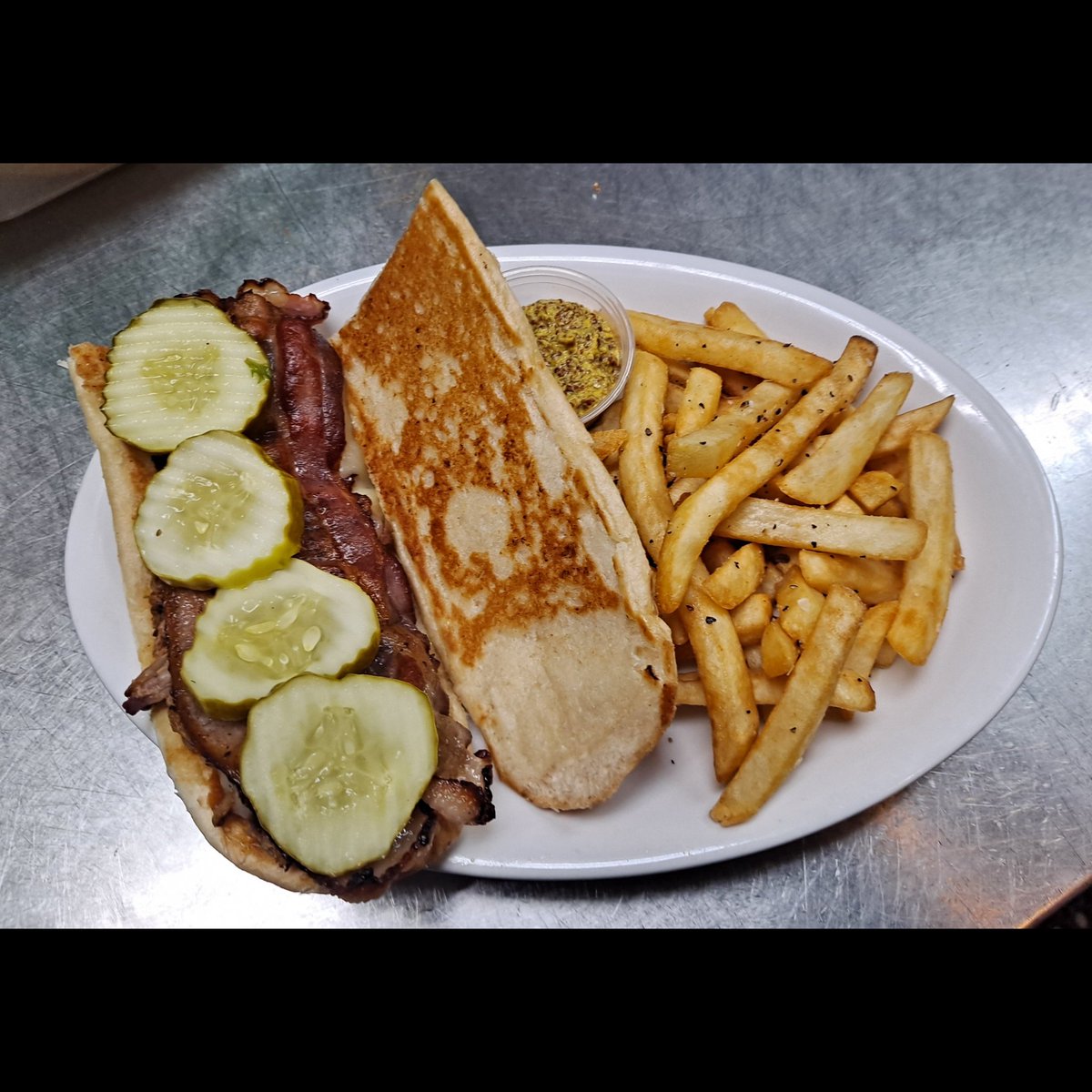 Weekly Food Special - Almost Cuban Sandwich! Featuring our house-smoked pork on a toasted bun, topped with habanero jack cheese, bacon, mustard, pickles, and accompanied by your choice of side. #BrewedOnBase