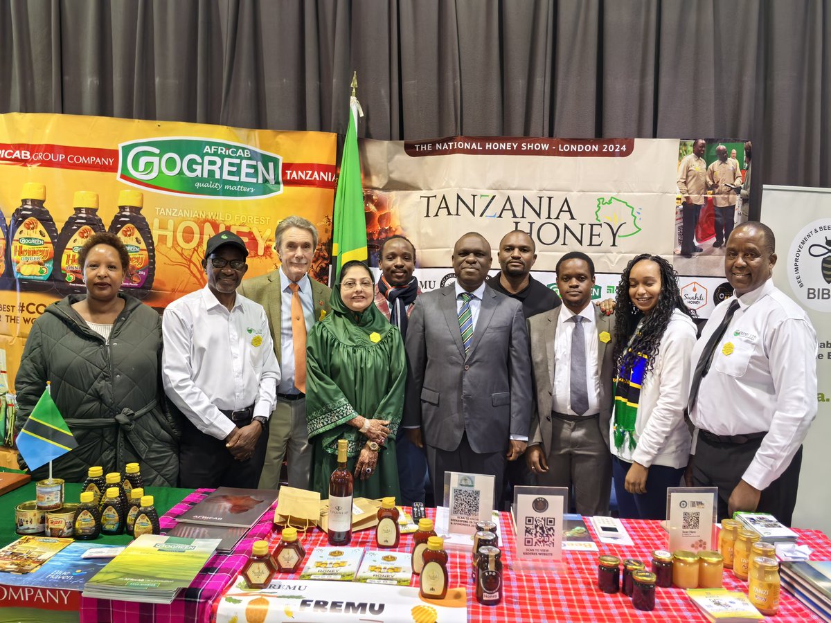 UbaloziUK's tweet photo. Asali ya Tanzania - Swahili honey, Go Green honey,  na Miombo yawa kivutio katika maonesho ya Asali yaliyoanza jana jijini London.  Imeelezwa kwamba kuanzia mwezi January 2025 asali hiyo itaanza kuuzwa katika maduka makubwa nchini Uingereza. Balozi @MbelwaK ametembelea maoenesho hayo leo na kutoa pongezi kwa Makampuni ya PMM, African Group, Central Park Bees na FREMU kwa kuchangamkia soko la Uingereza na amewaahidi ushirikiano wa Ubalozi katika kutafuta masoko mapya
