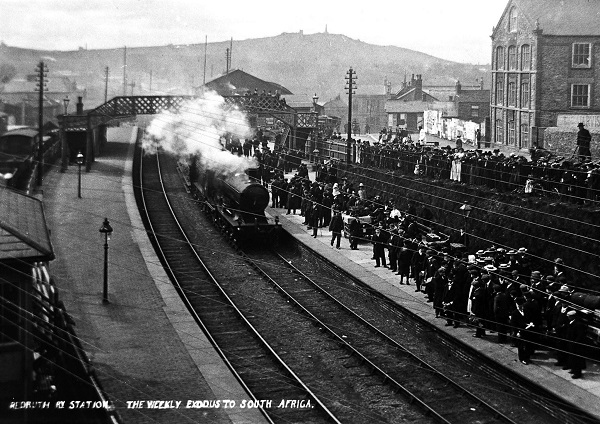 Emigration became a common occurrence in Cornwall throughout the 19th &amp; 20th centuries, with increasing numbers of young men - like miners and telegraph workers - heading abroad in search of new opportunities.   This postcard shows the ‘weekly exodus’ of miners to South Africa.