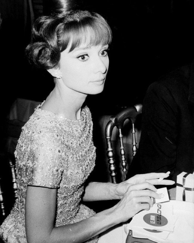 Worn #onthisday in 1962 by Audrey Hepburn (with husband Mel Ferrer) to a gala honoring the World War II film "The Longest Day" at the Palais De Chaillot in Paris, France. Her Autumn/Winter 1962 @Givenchy beaded pink silk gown is now in the Henry Wilkinson Collection. #OTD