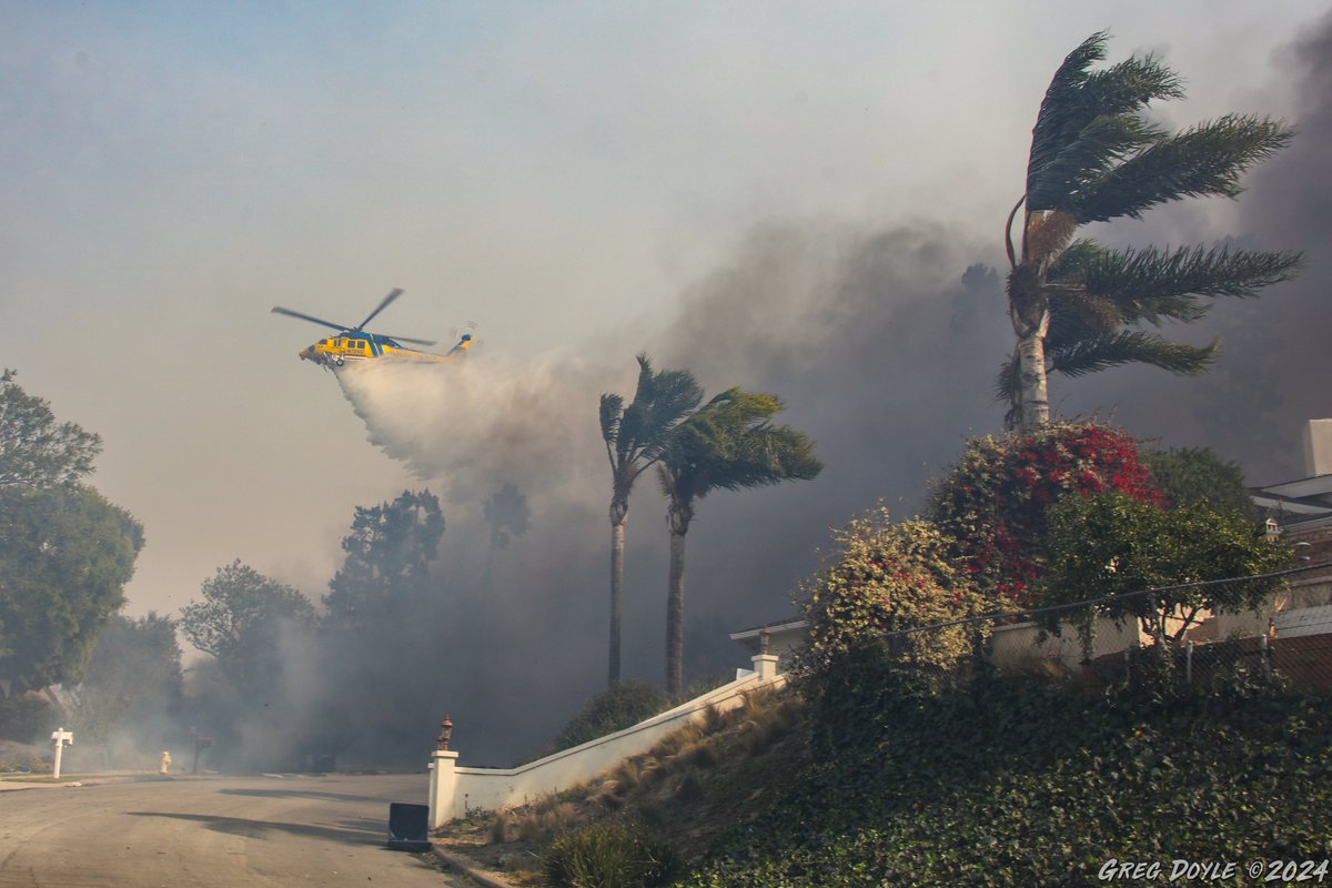 With the howling wind pushing the Mountain Fire deeper into Camarillo Wednesday, Copter 4 from <a href="/VCAirUnit/">VenturaCoAirUnit</a> makes a drop along Garrido Drive, where homes were beginning to burn.  There was just no stopping this fire. <a href="/VCFD_PIO/">VCFD PIO</a> <a href="/CALFIRE_PIO/">CAL FIRE PIO</a>