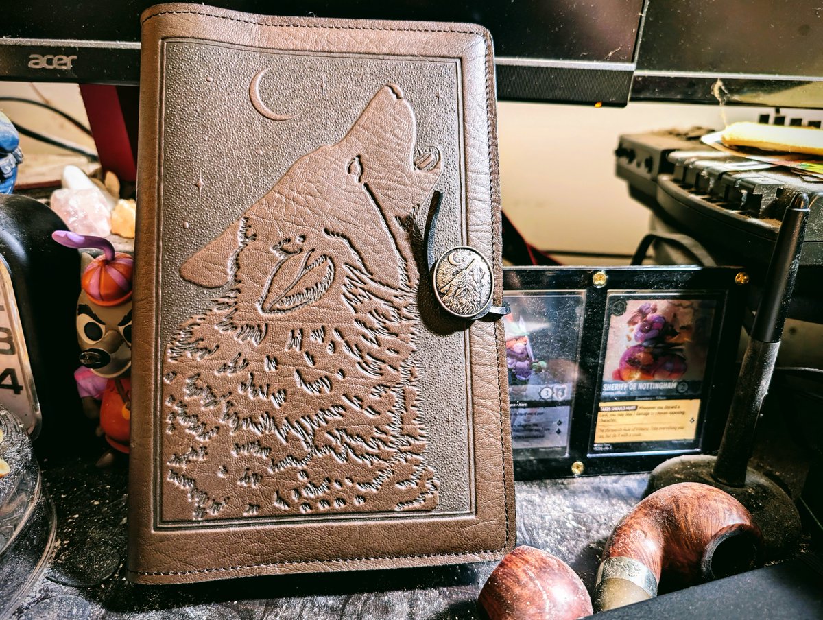 glosynge's tweet photo. Even as a prodigal collector of notebooks &amp; lupine artifacts, I had to dote especially on this handsome new manuscript-cover!

[I can still hear @PawsonRonnie tut-tuttin' my ash-strewn desk, ha!]

To christen it, I notated directions fer locatin' a bardic-wolf amidst the exodus. https://t.co/9HVnbQ3Lfp