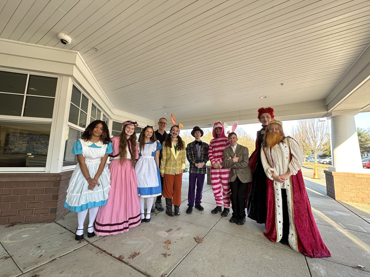 UpperMerionSD's tweet photo. The HS cast of Alice in Wonderland made a lively appearance at Candlebrook yesterday, mingling with parents &amp; students at dismissal to build excitement for their upcoming performances.  Their visit brought a touch of wonder &amp; anticipation to the end of the day! https://t.co/w6WCeCiuPx