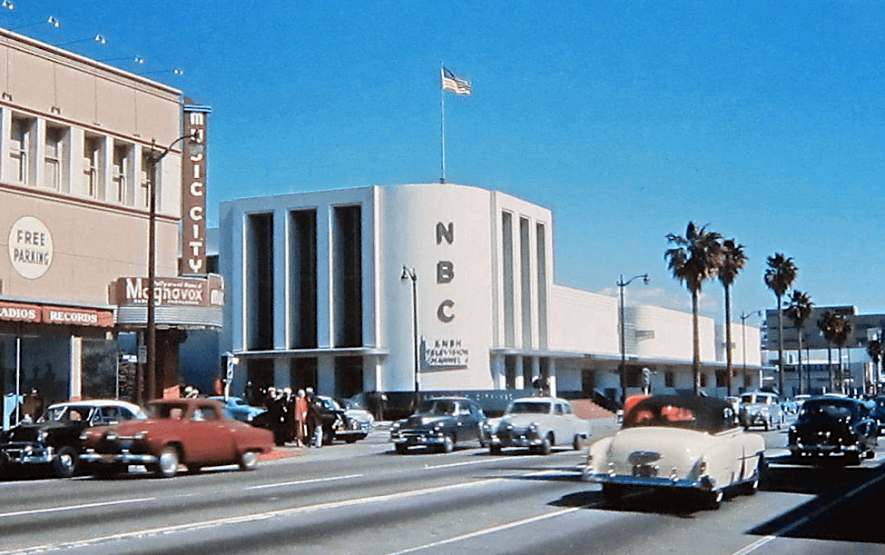 TurnbullMartin's tweet photo. I do love finding a Kodachrome image! We're looking east thru the intersection of Sunset Blvd and Vine St, Hollywood, circa early 1950s. When photo was taken, NBC  had converted to TV. That 2-toned car on the right is a 51 Chevrolet convertible, so let’s call this circa early 50s https://t.co/ecEeA8J3Le