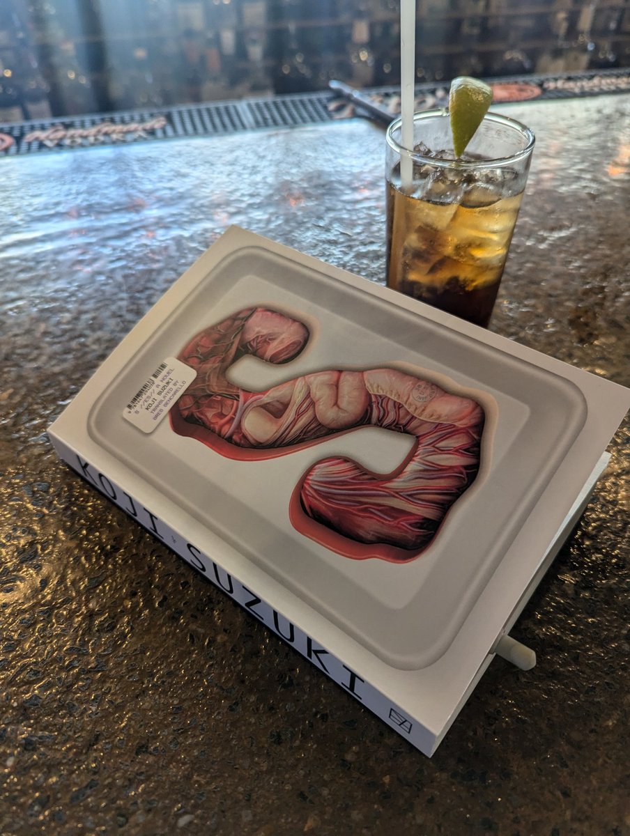 A book and a drink - trying to do something that feels normal.