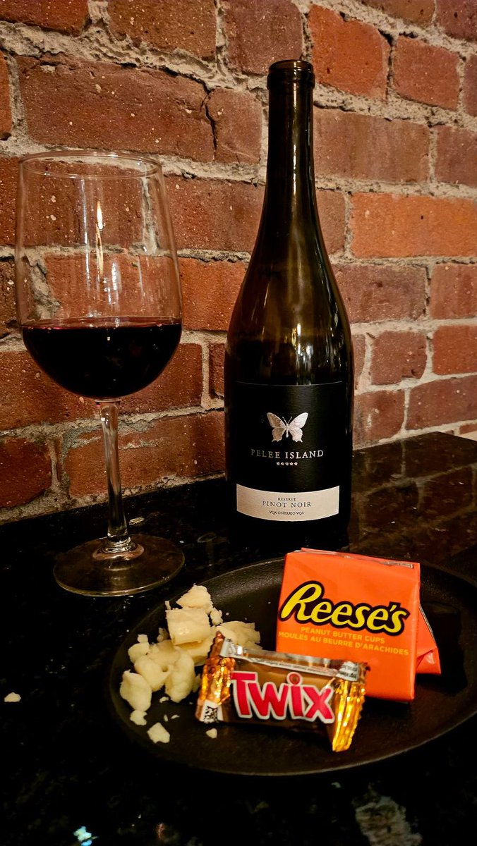 Happy HALLOWEEK! 🎃 👻 🕷️ 

$14!! 
Glass of Pelee Island Pinot Noir 
Twix &amp; Reese’s treat
Aged Cheddar Cheese

#halloween #twix #food #foodnl #happyhourspecials #halloweenspecial #agedcheddar #reesespeanutbuttercups #foodiegram #yyt