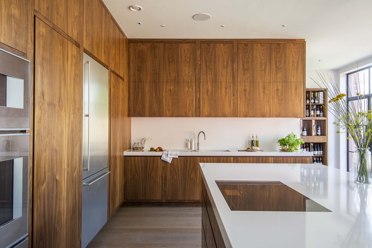 Project 6296 – We were commissioned to design and build a modern kitchen to feature in this newly established space. The final design concept included a central island, three runs of floor-to-ceiling cabinets, a dedicated bar area, wine display and bespoke 8-seater dining table.