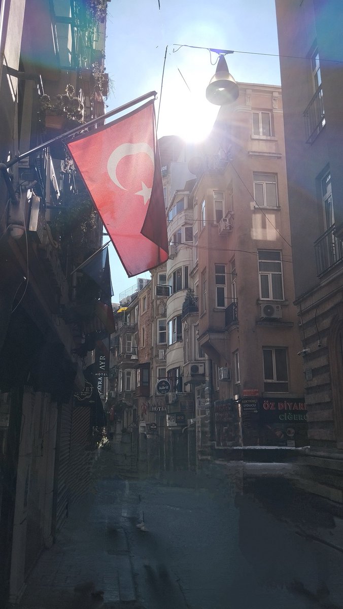 Father_Ahab's tweet photo. Side streets of Istanbul, off Istiklal Street, draped with flags to celebrate Republic Day. The ☀️ is rising https://t.co/iYJyhNKO0D