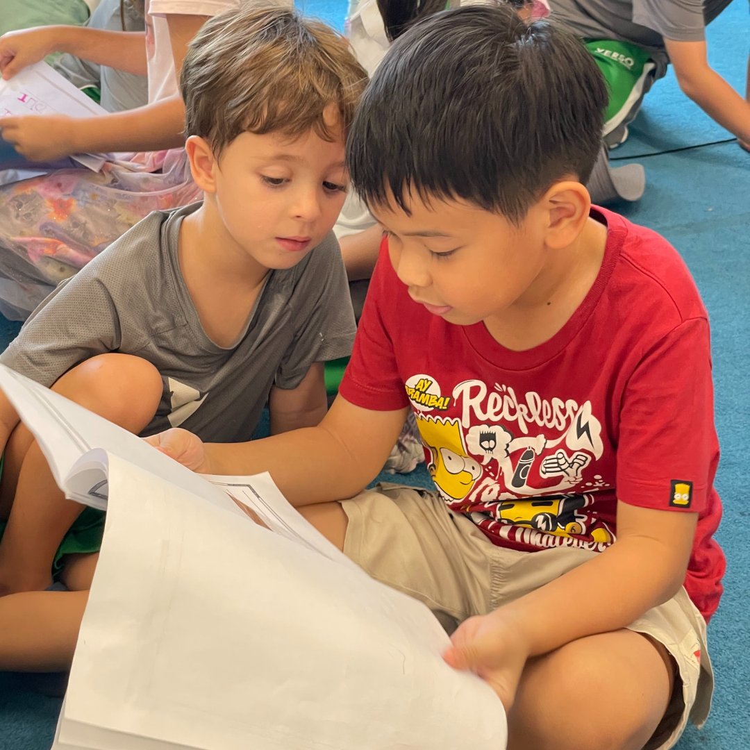 C1-2 learners celebrated the end of the quarter by sharing their "how to" books they designed and wrote. They chose to create these books for their younger peers in EY 4-5, focusing on basic tasks like lining up, tidying up, and brushing teeth to support their community.