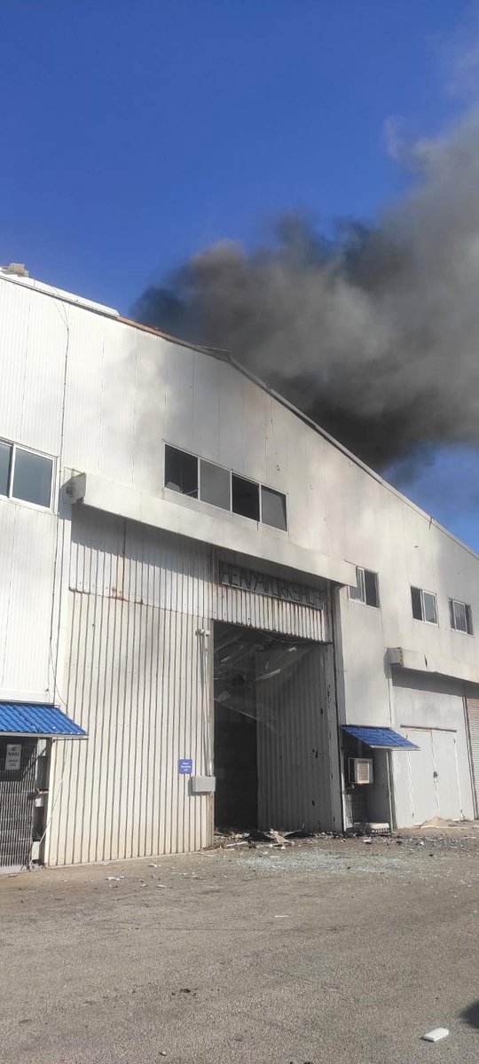 UNIFIL_'s tweet photo. Statement: 

This afternoon a rocket hit UNIFIL’s headquarters in Naqoura, setting a vehicle workshop on fire. Peacekeepers were not in bunkers at the time. While some peacekeepers suffered minor injuries, fortunately no one was seriously injured. https://t.co/MuJ1sOEnQR