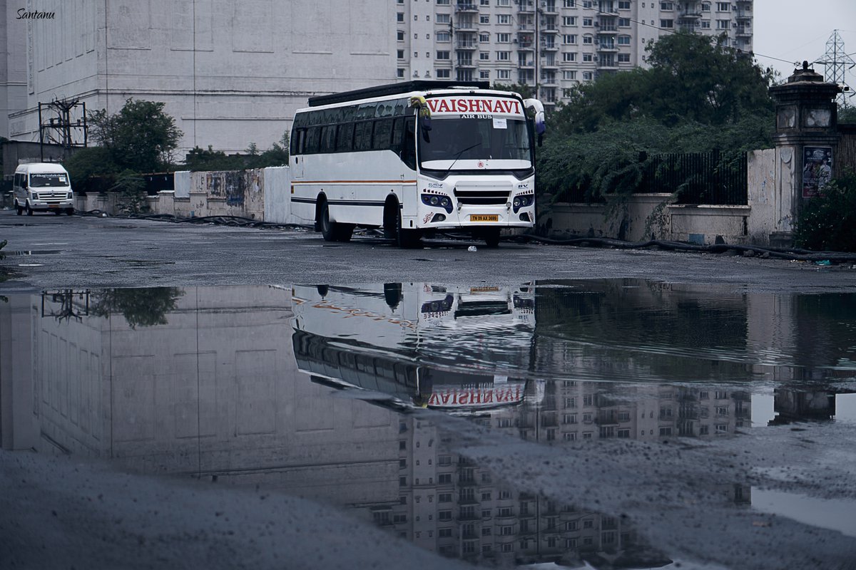 Santanu_pl's tweet image. &quot;Silent bus, reflected in rain&apos;s embrace,  
Waiting for the road, in a still, quiet space.&quot;
.
CHENNAI Street photography 
#UrbanStillness #ReflectionsInTime