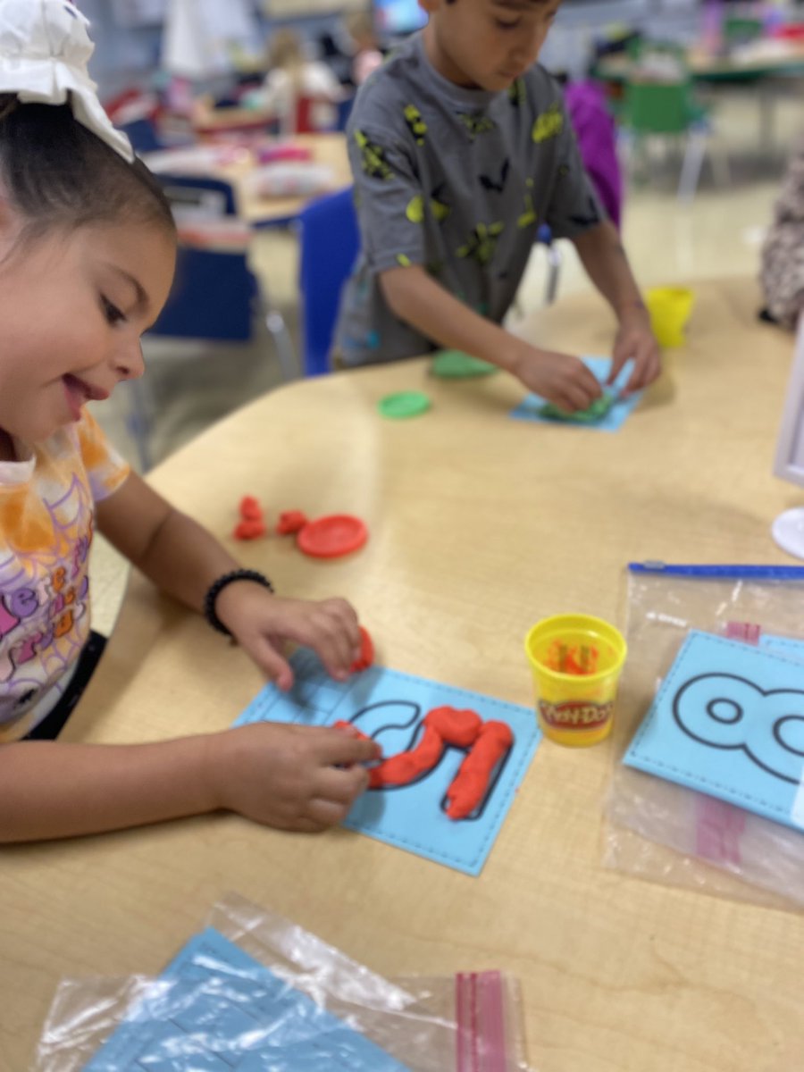 Kindergarten WIN working on number formation and 10-frame counting with play-dough!