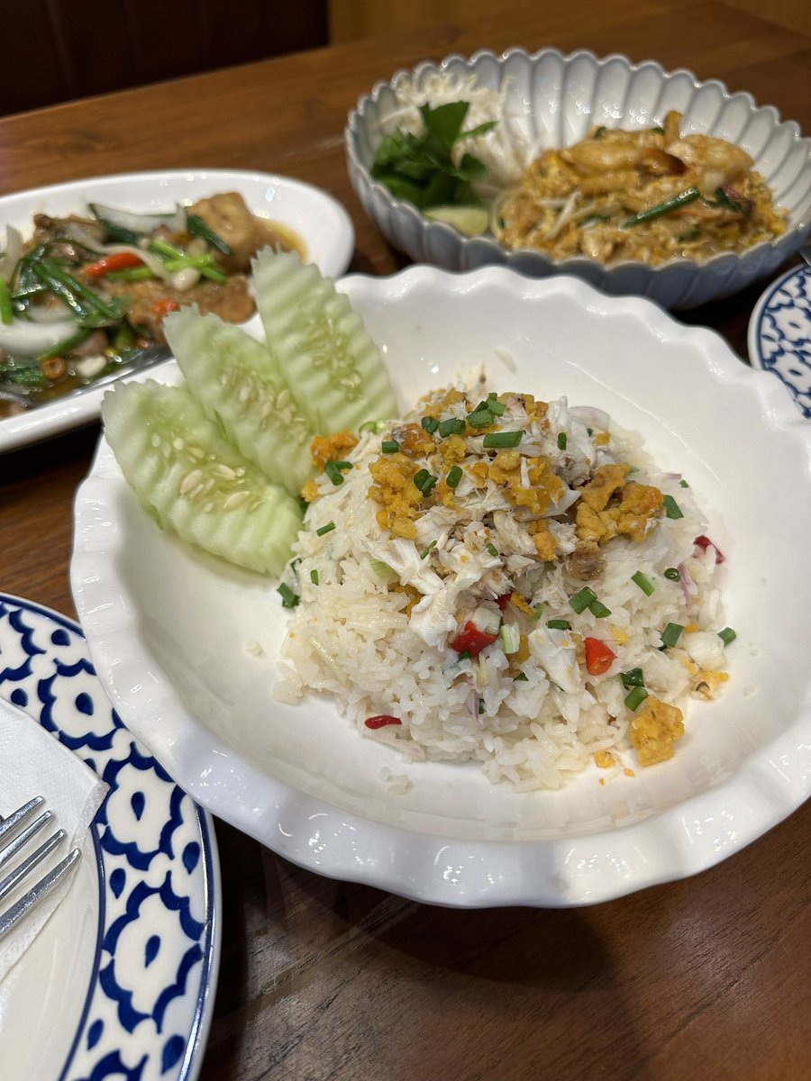 A beautifully presented dish of Thai-style Steamed Crab Rice, topped with fresh herbs and crispy garnishes, served with cucumber slices for a refreshing balance. #MBK