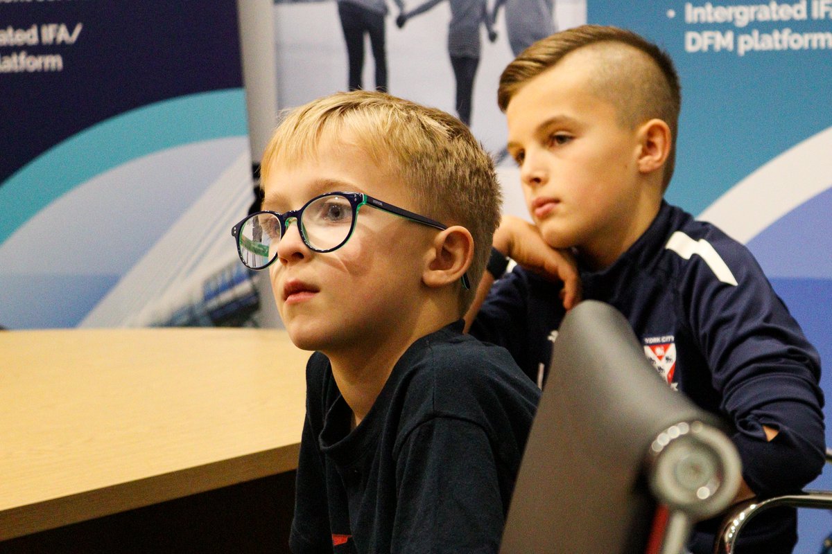 YorkCityFC's tweet photo. 🦁 A number of Junior Reds were invited to sit in on Adam Hinshelwood's press conference this afternoon, pitching their questions alongside experienced, local journalists!

Still time to become a Junior Red via https://t.co/pMi0mmiOia if the young person in your life isn't already! 

#YCFC 🔴🔵