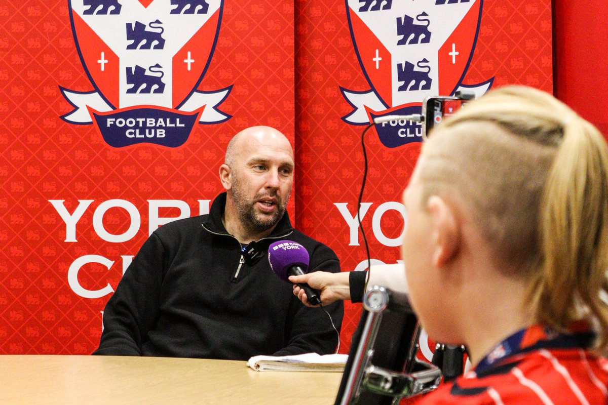 YorkCityFC's tweet photo. 🦁 A number of Junior Reds were invited to sit in on Adam Hinshelwood's press conference this afternoon, pitching their questions alongside experienced, local journalists!

Still time to become a Junior Red via https://t.co/pMi0mmiOia if the young person in your life isn't already! 

#YCFC 🔴🔵