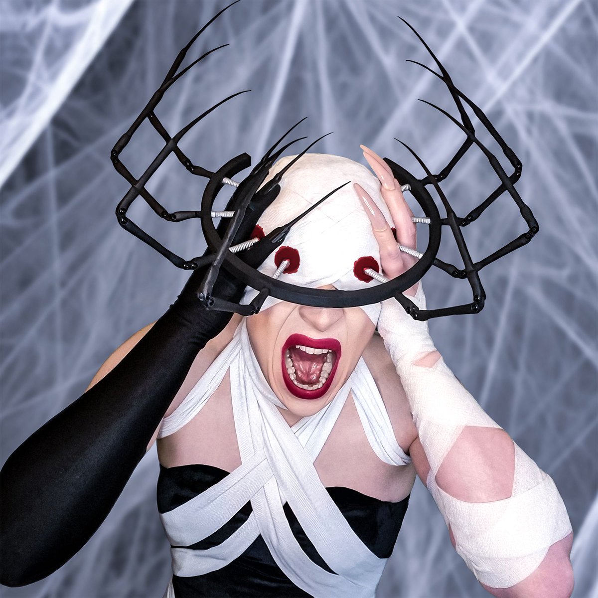 Cocooned with our tangled selves 🕷️🕸️ EMBRACE, my second Halloween design, combines surgical and spider imagery to explore the challenges of isolation, introspection, and transformation in the process of recovery. #millinery #headpiece #halloween #spider #disease #horror