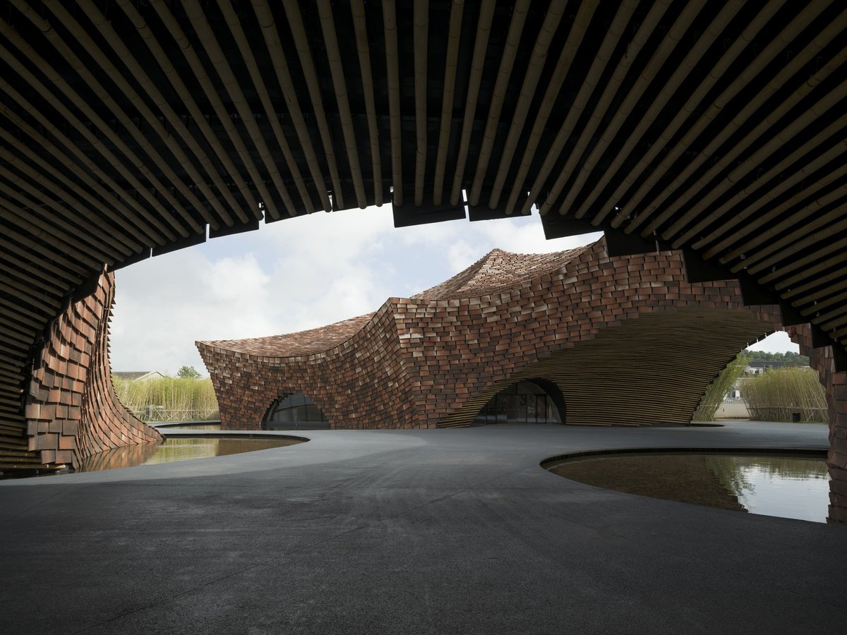 ArchDaily's tweet photo. The UCCA Clay #Museum reflects Yixing's ceramic heritage, with a form inspired by Shushan Mountain and the traditional dragon kiln. It connects with the canal and the former pottery factory axis.   https://t.co/cBLFjfjPl2 https://t.co/FKzQjs5jqd