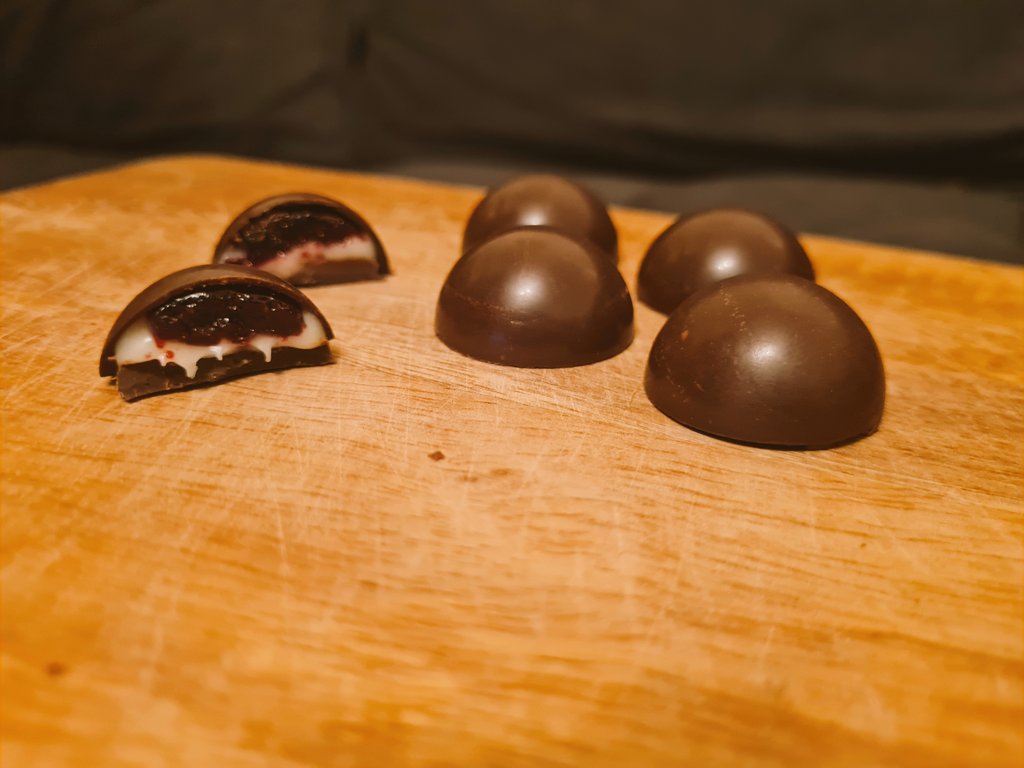 Experimenting with homemade chocolates.

After a lot of failures have come up with something pretty happy with. Dark chocolate bon bons with a mixed berry jelly and white chocolate ganache centre.