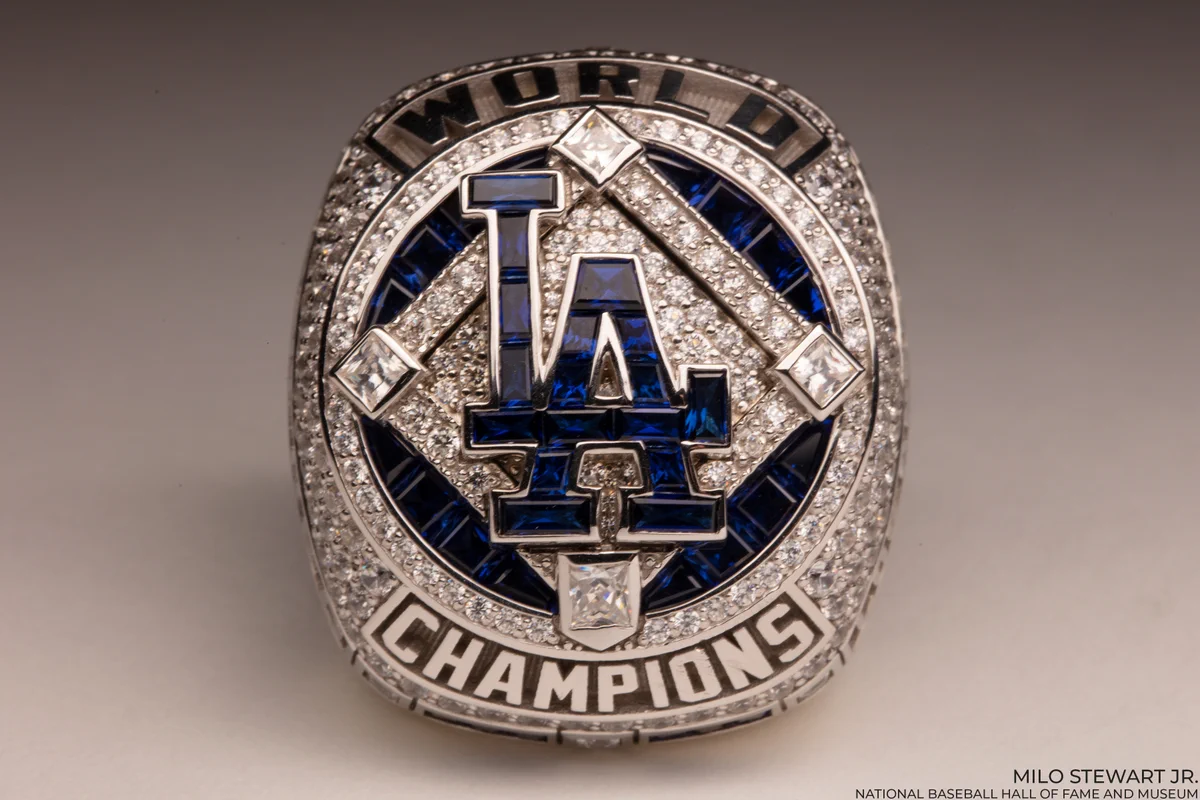 Los Angeles Dodgers 2020 World Series ring with an LA logo made up of dark blue gemstones surrounded by clear gemstones arranged in a diamond shape. (Milo Stewart Jr./National Baseball Hall of Fame and Museum)
