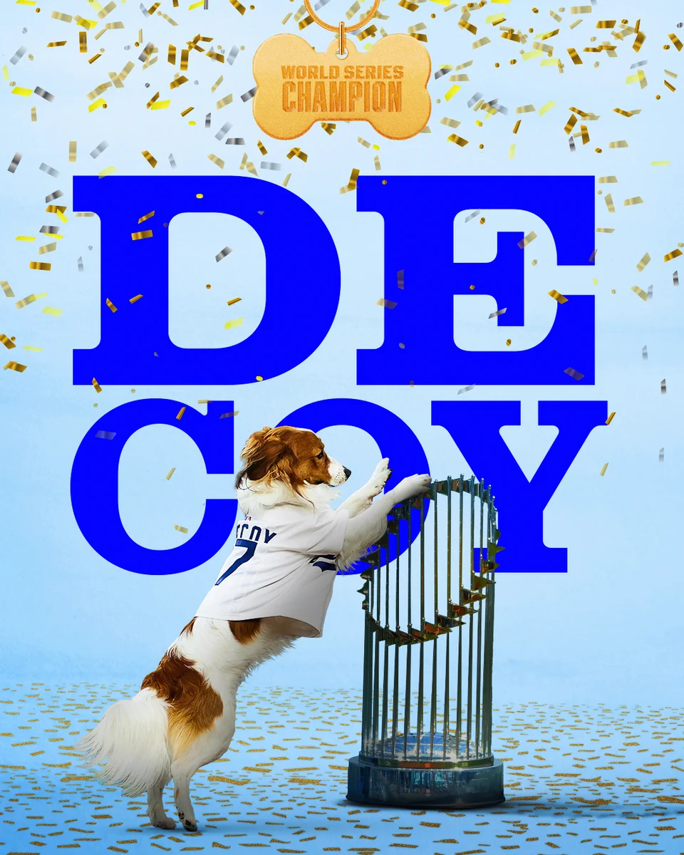 Decoy Ohtani, dressed in a Dodgers jersey, stands on the World Series trophy. A collar tag reads "WORLD SERIES CHAMPIO