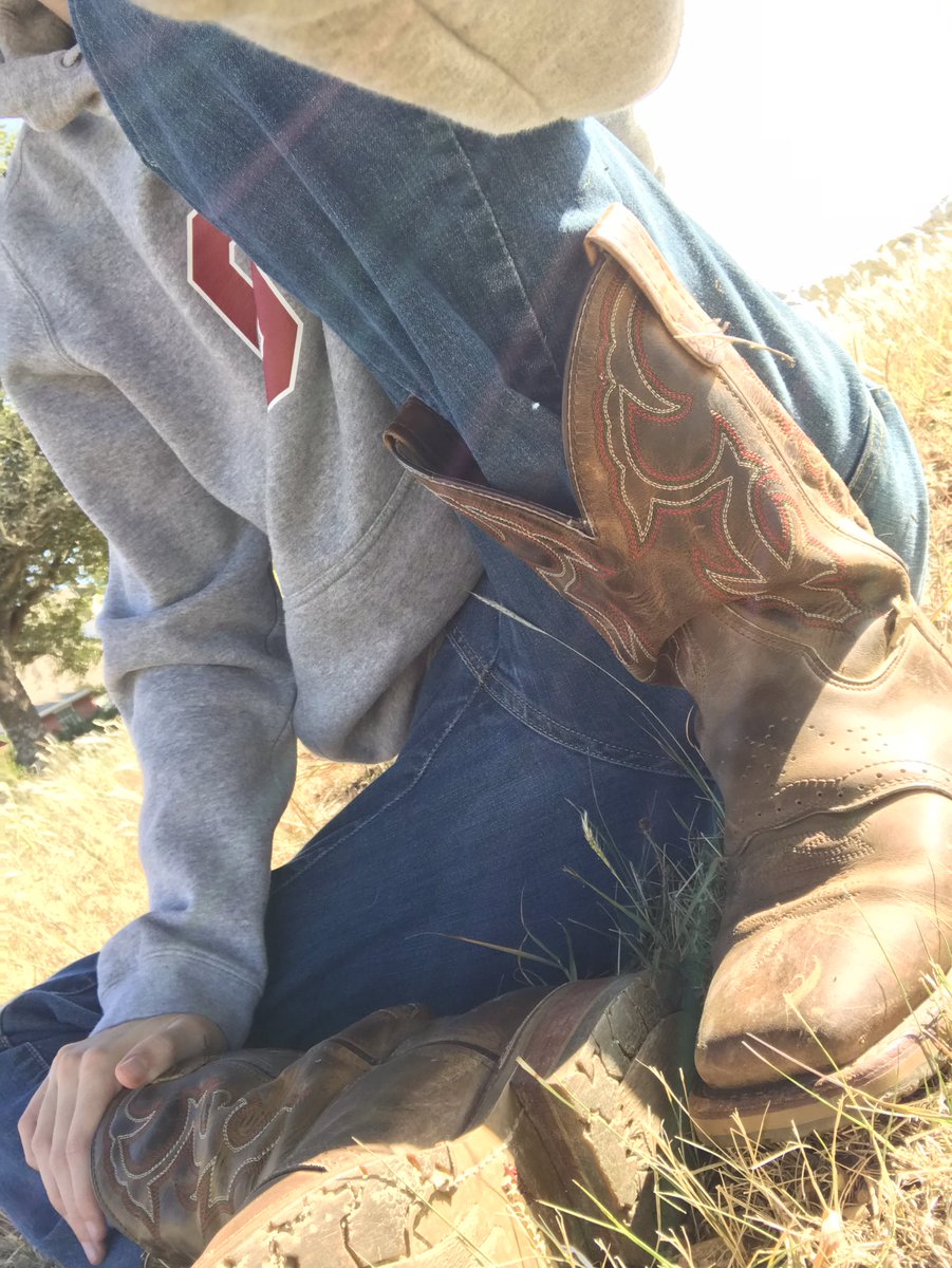 Cosplay of guy with college sweatshirt and jeans and cowboy boots