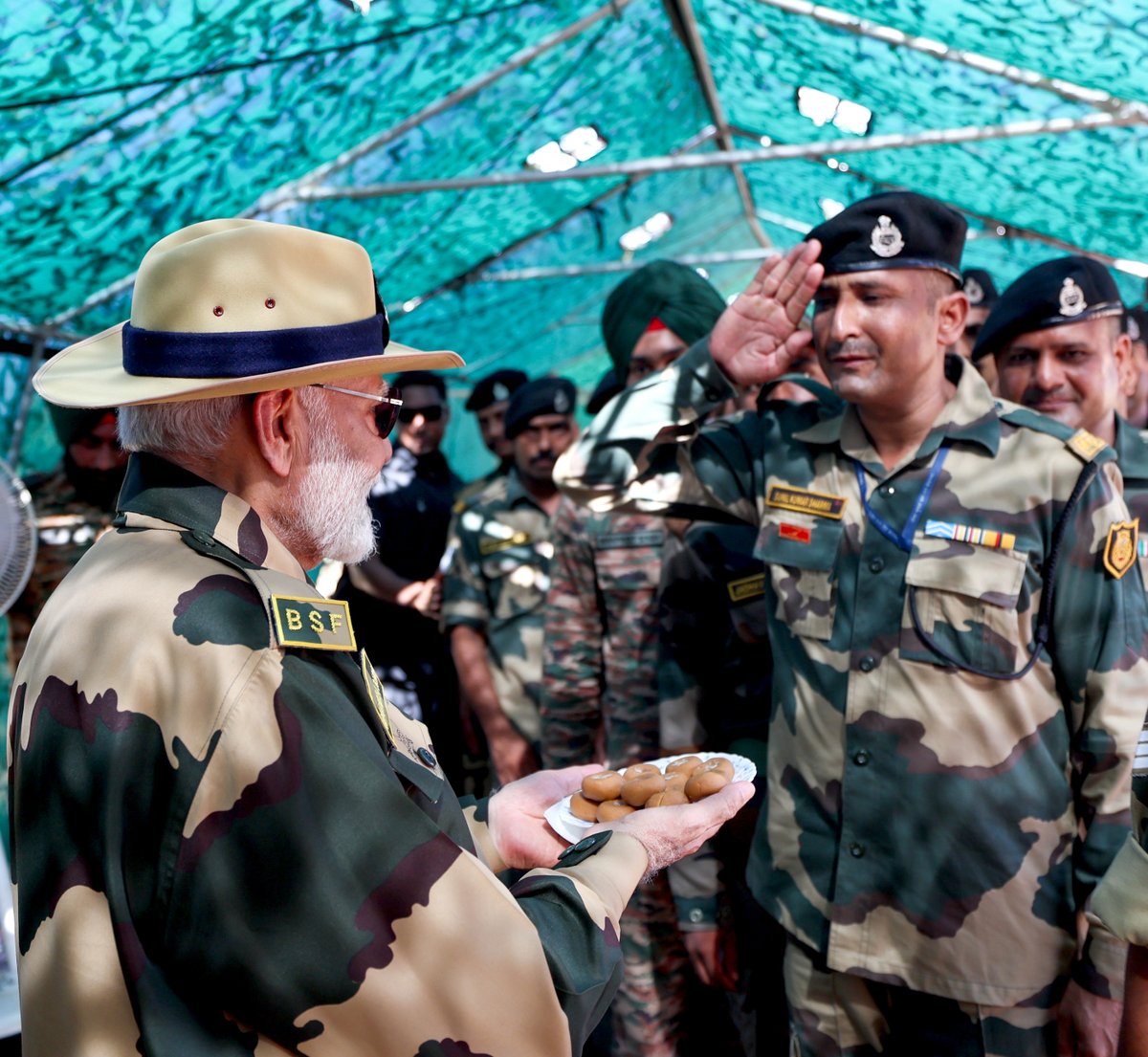 narendramodi's tweet photo. Glad to have celebrated Diwali with our brave personnel from the BSF, Army, Navy, and Air Force at Lakki Nala in the Creek Area, Kutch. This area is both challenging and remote. The days are scorching hot and it also gets cold. The Creek area has other environmental challenges as well.