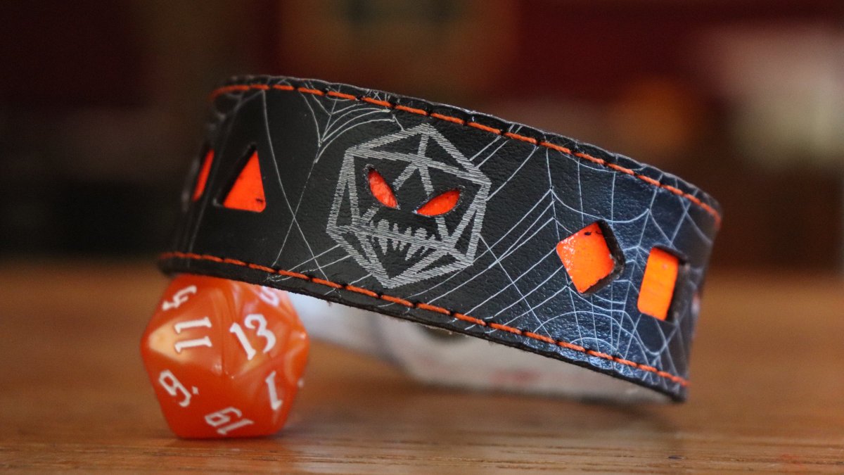 SpeechlessBard's tweet photo. Happy Halloween! 🎃
It's the last day for our cute Dice-o'-Lantern bracelets, so grab one while they're still in our shop. We'll bring a small batch of orange bracelets to  @FACTSConvention this weekend, but after that they'll be gone! 👻
#halloween #ttrpg #leathercraft https://t.co/uBn6nTnDTM