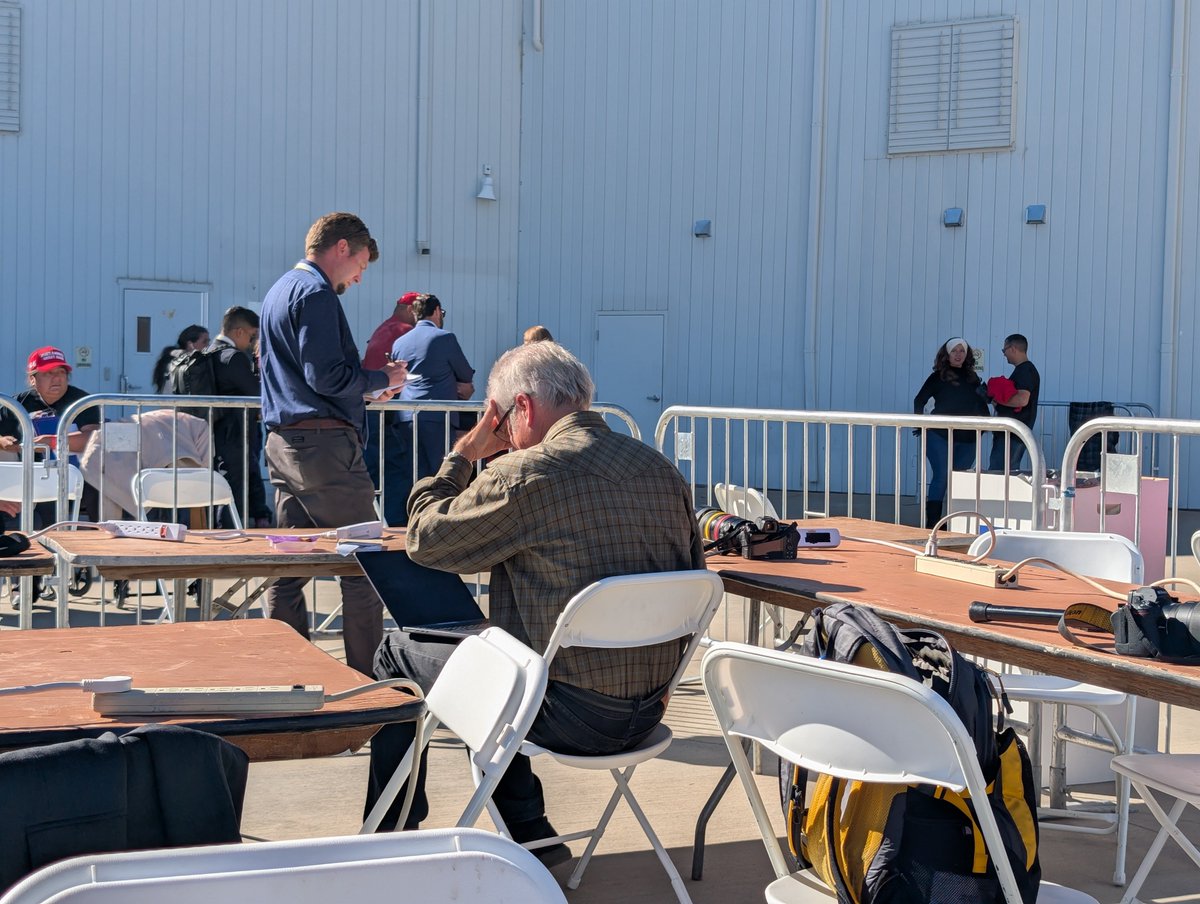 The photojournalists editing in the sun.