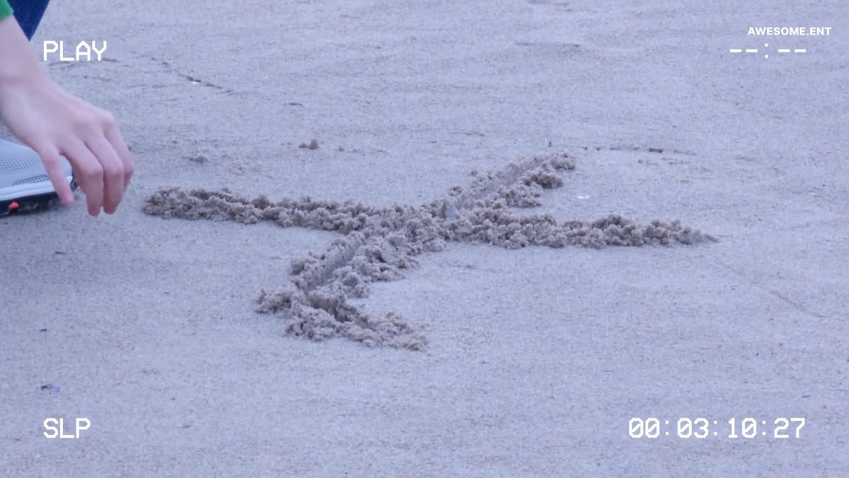 NJHIST0RY's tweet photo. Nation first love indeed 

( she also mentioned in her vlog that she will be filming "Dear X" soon so she won't be able to see the sea for awhile, so I think she drew X on the sand to celebrate that awe ) https://t.co/tOzE4U591s