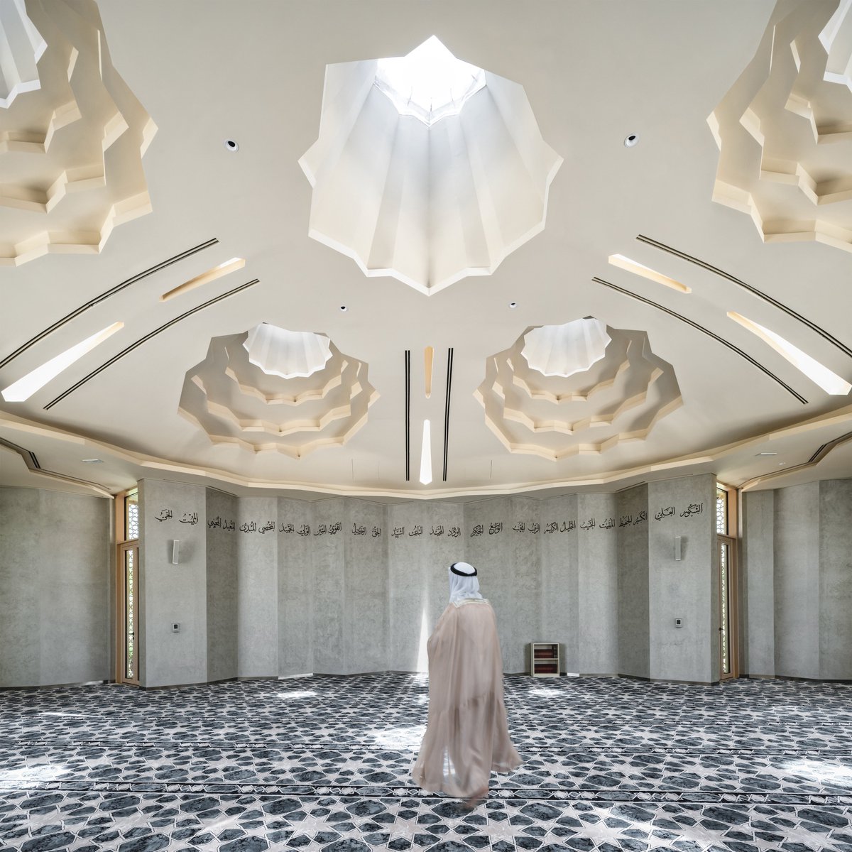 The mosque’s passive design uses compact skylights and Arabic screens to maximize natural light while reducing heat and cooling needs.