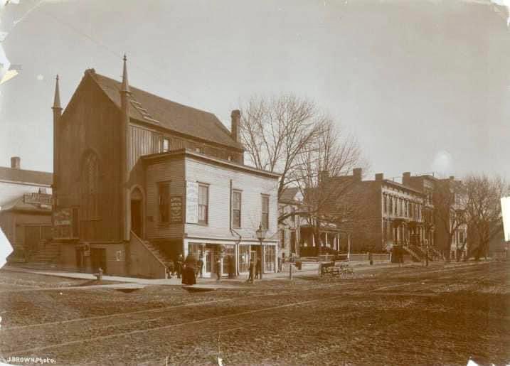 c1880 - We’re looking at the NE corner of Jefferson &amp; Michigan Sts at an unknown church with a shop attached. Notice the gas street light and beautiful row homes down the street. The Federal Courthouse was built on this block beginning in 1892. 

Photo:  Joseph Brown/MPL