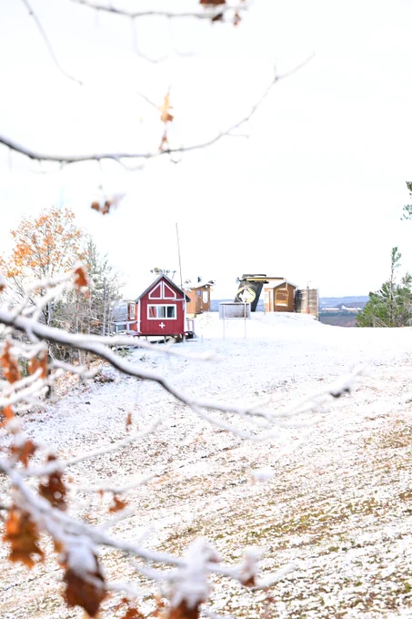 Michigan Tech's  Mont Ripley ski hill is covered in a light dusting of snow. The Husky chairlift and ski patrol shed is seen in the distance.