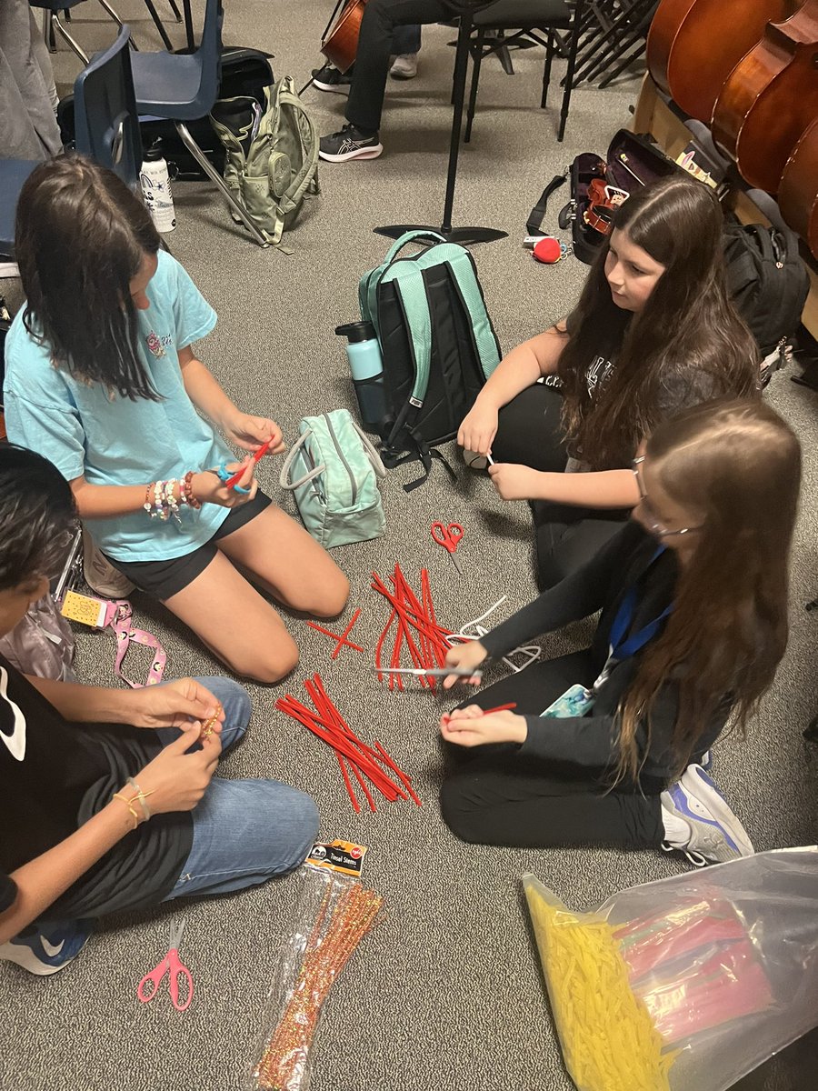 NIS_Orchestra's tweet photo. Life principle of the week- Service.  Orchestra students helping cut  our “wildcat stripes” so Mrs. Shah can celebrate their accomplishments! https://t.co/gajSXhKaVO