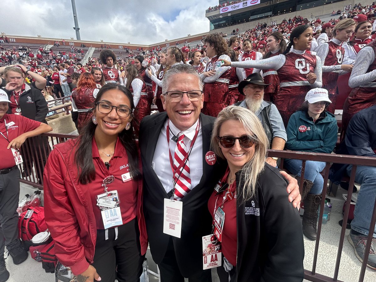 OUNursing's tweet photo. CON faculty Dr. Erica Melick &amp; LPN-BSN student Megan Upshaw taking care of the @OU_ThePRIDE today rain or shine!  Great shots with our @UofOklahoma Pride friends, featured twirler Sammy with Allie &amp; Kylie &amp; Brian Britt, OU Pride Director!  #OUNursing #OUNursingHealthTeam https://t.co/ktolLXNwck