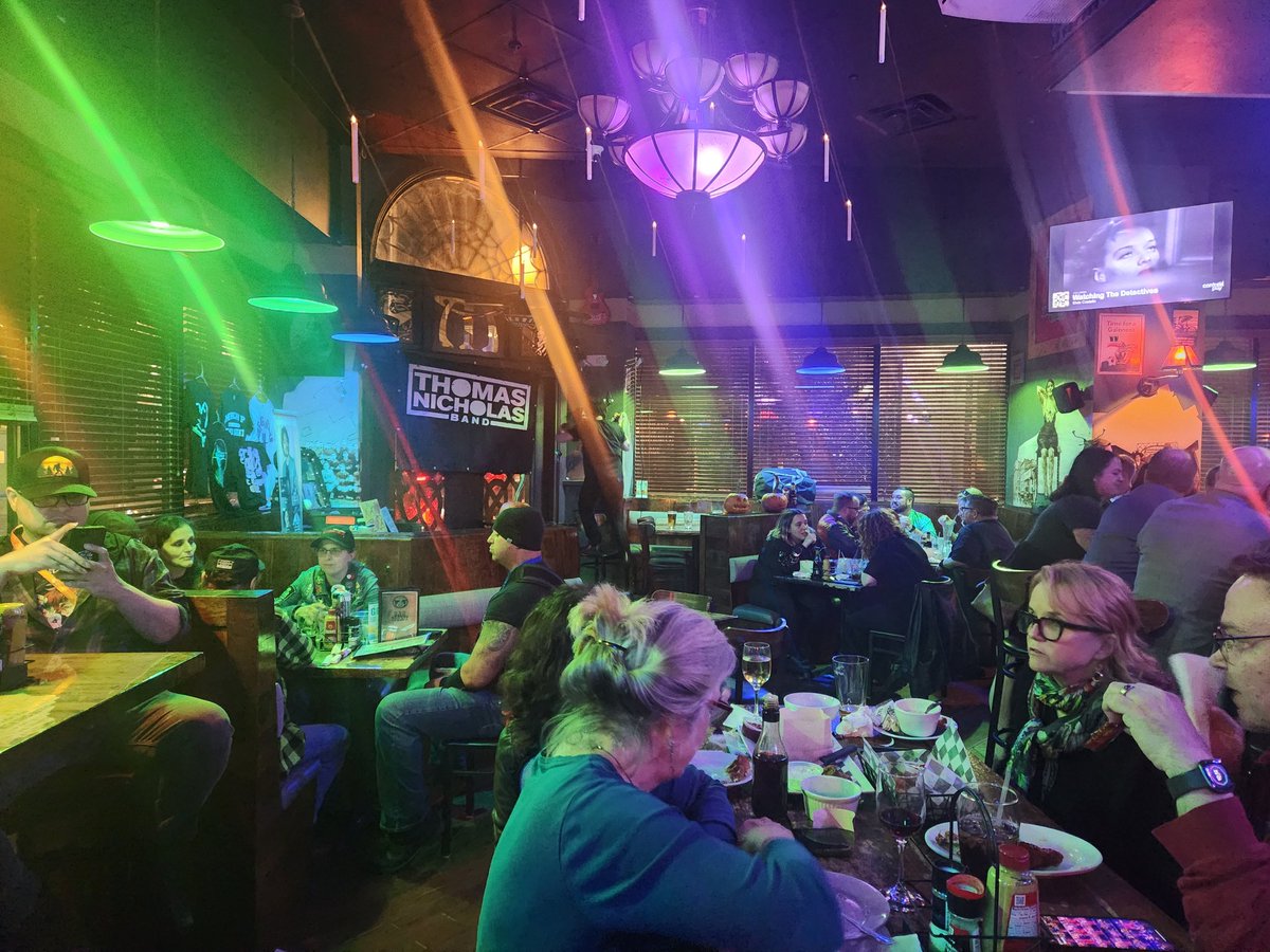 TheChippa's tweet photo. I bought @TINBand's new album and had it signed.  Then saw him play a show at Murphys Pub.  I was later informed that Leah Thompson was sitting at the same table as me and Tara Reid was there watching the show.  They are in the photo, see if you can spot them. https://t.co/9qapAHxop0