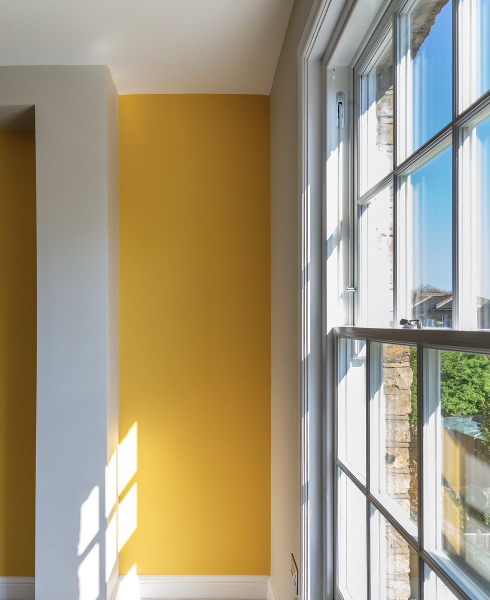 This space explores the dynamic relationship between natural light and bold colour. The vibrant yellow accent wall energizes the room, contrasting with the soft neutrals and clean lines of the window framing

#bydobuild #dobuild #fineconstruction #CIOB #BIID #TheList #RIBA #ARB