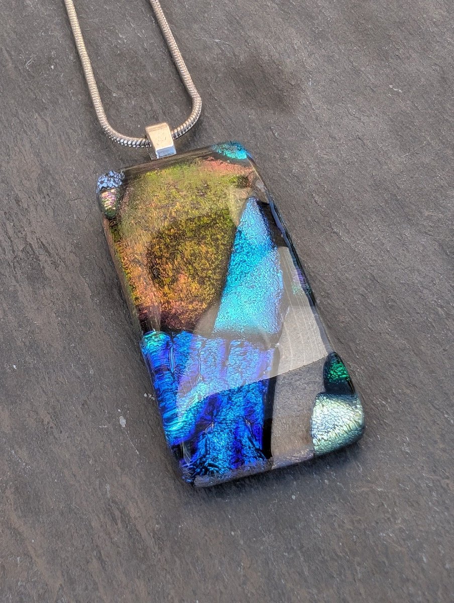 Beautiful sparkling dichroic glass necklace. Lovely golds, blues and greens within this handcrafted pendant.

#ukgifthour #ukgiftam #handmade #etsy #shopindie #giftideas
 
buff.ly/4cCJX3U