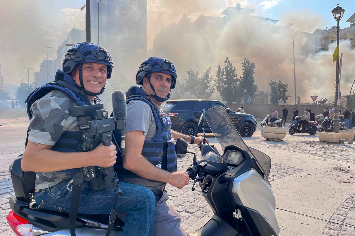 AP cameraman Fadi Tawil, right, and assestent Mohammad Anouti pose for a photo scooter as they cover an aftermath in Dahiyeh, Beirut, Lebanon, Friday, Nov. 1, 2024. (Hussam Shbaro via AP)