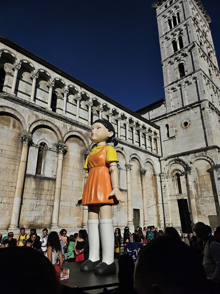 vertigocave's tweet photo. lucca comics was so fun like wdym there's a dragon ball z sign and the squid game doll in the historical centre of the city https://t.co/fxGsSHDZTm