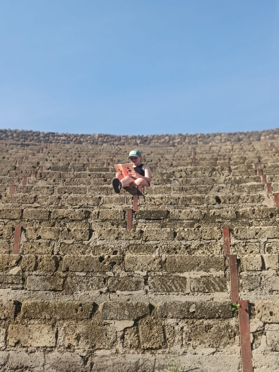 joleene79's tweet photo. Robyn Bradley, 4M enjoying her new book during her travels around Rome, this is sitting in the Pompeii ampitheatre
@ololprimary_HT
#extremereadingchallenge https://t.co/KYt1TKfae3