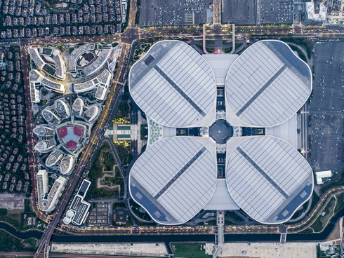 CGTNOfficial's tweet photo. Painted in different colors, the city of Shanghai exudes a unique quality. The passionate red cloaking the seashore in the early morning contrasts with the soothing green that envelops a city park in the mid-summer. The muted blue radiating from the roof of the venue hosting the upcoming China International Import Expo conveys the stability and reliability of modernity, while the vibrant orange that engulfs the Shanghai port reveals the energy hidden in the tranquility of the nightfall. #CIIE2024 #Shanghai
