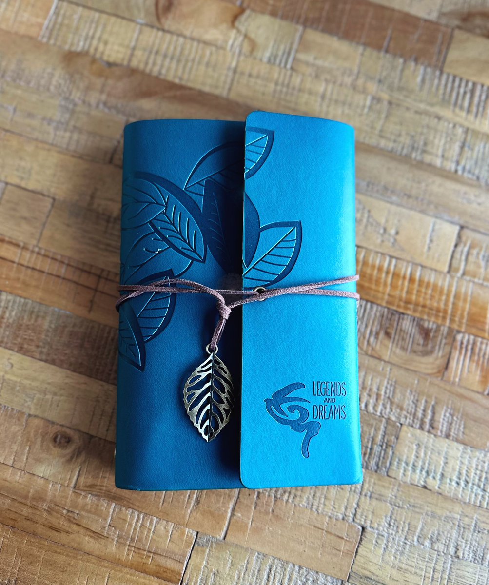 Legends &amp; Dreams Journal Travel Notebook - Teal 
Introducing the Legends &amp; Dreams Traveler's Journal – a beautifully crafted notebook that blends elegance with functionality, perfect for note-takers, writers, travelers, and dreamers alike. The journal is wrapped in a soft, imi...