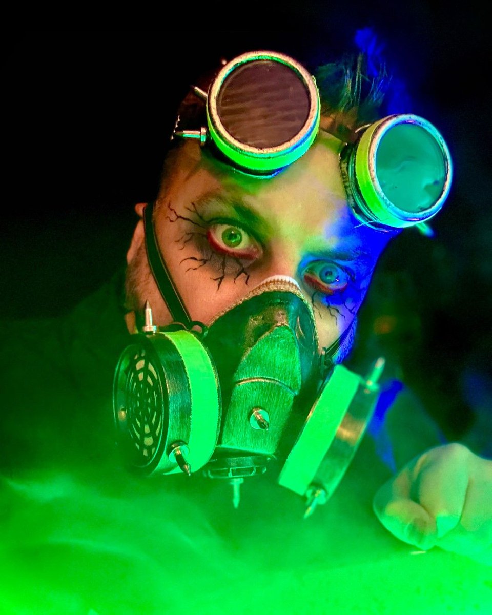 ZombiePumpkins's tweet photo. Embraced the toxin theme for Halloween. Went as a toxic waste worker with goggles, a jumpsuit, and black light-reactive accents. My yard props were part of the look—a barrel of glowing green slime, fog, and a skeleton reaching out, all under eerie green and black lights. https://t.co/Q2z0dfTDSX