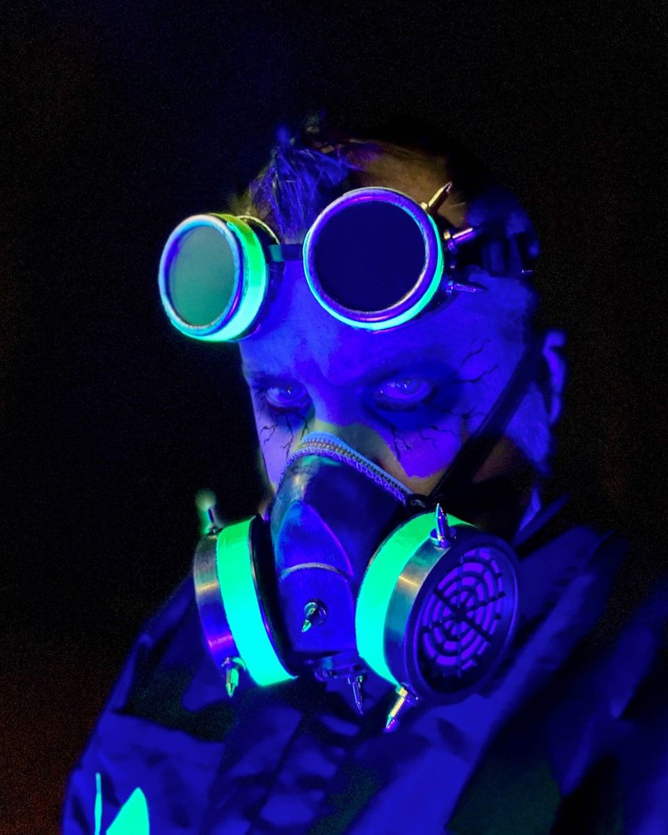 ZombiePumpkins's tweet photo. Embraced the toxin theme for Halloween. Went as a toxic waste worker with goggles, a jumpsuit, and black light-reactive accents. My yard props were part of the look—a barrel of glowing green slime, fog, and a skeleton reaching out, all under eerie green and black lights. https://t.co/Q2z0dfTDSX
