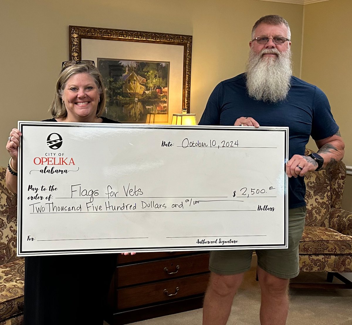 Leigh Krehling, Community Relations Officer for the city, presents Jamie Popwell with a check for Freedom Fest -- an event put on by Flags for Vets to honor those who have served our country. Come to downtown Nov. 23 from 3 - 11 p.m. and enjoy the day. facebook.com/events/8848746…