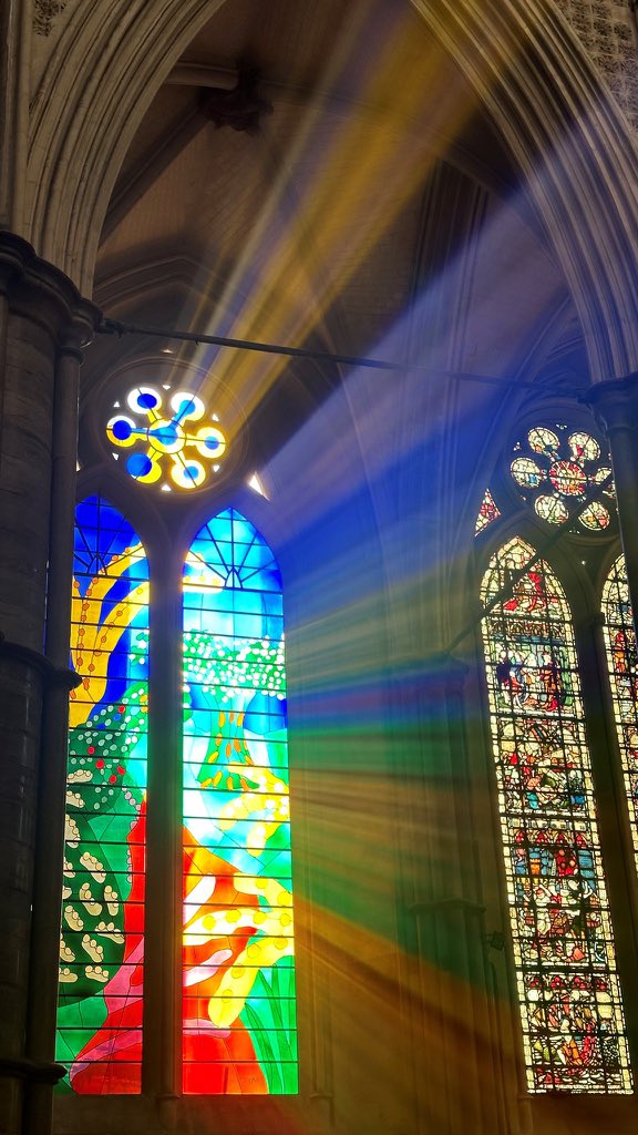 wabbey's tweet photo. Afternoon sunlight streams into the Abbey through The Queen's Window, designed by David Hockney and installed in 2018 to celebrate the reign of HM Queen Elizabeth II. It depicts a vividly coloured country scene reflecting The Queen's deep affection and connection to the countryside.

#Museum30 #Glow