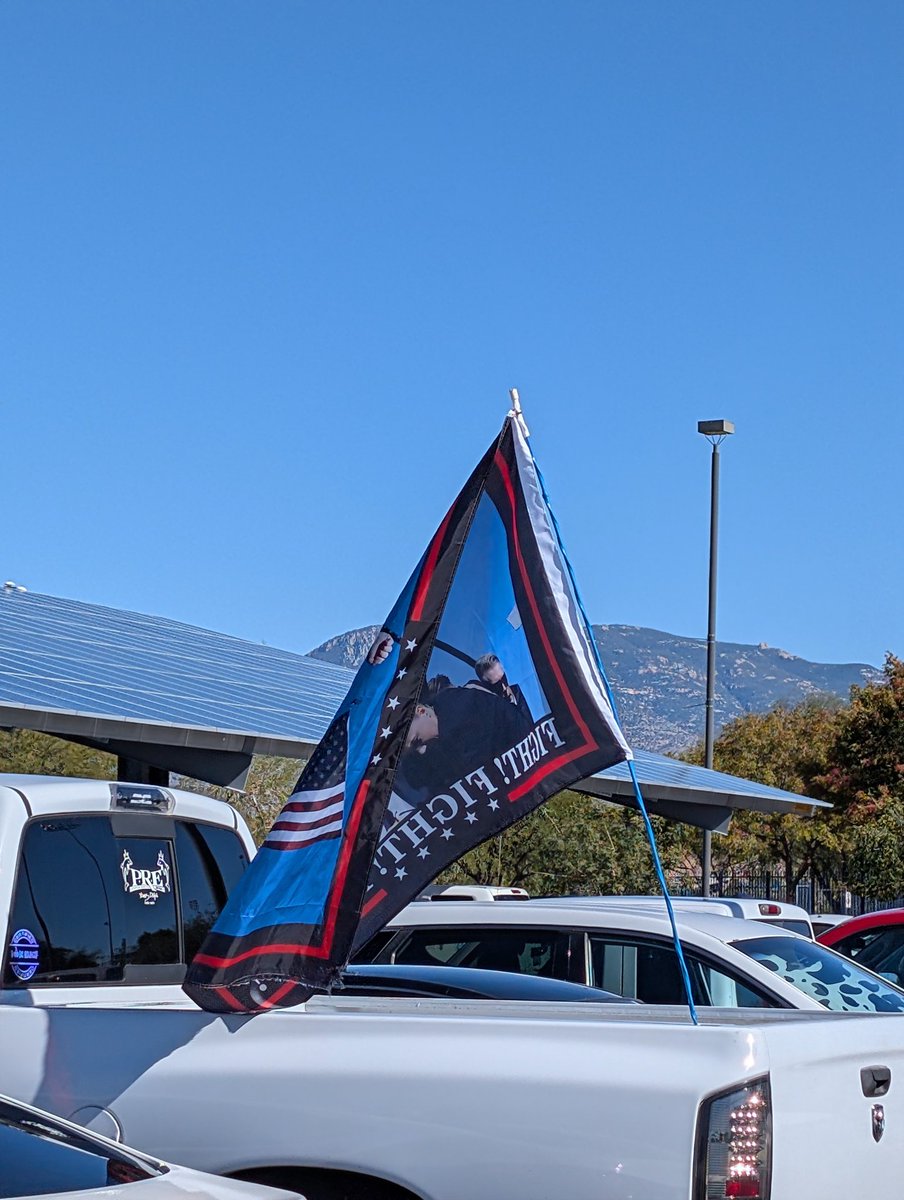 I was leaving my voting place, a high school in Tucson, AZ. Just ahead of me was a student walking to the parking lot carrying this flag, surrounded by his friends. God bless America!