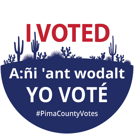 #IndivisibleTohono #GetOutTheVote [alt-text: Round sticker w/ silhouette of desert plants. Text reads: "I VOTED" then below "A:ñi 'ant wodalt" [in the Tohono O'odham Language] and "YO VOTÉ" [in Spanish]. Embedded hashtag includes #PimaCountyVotes]